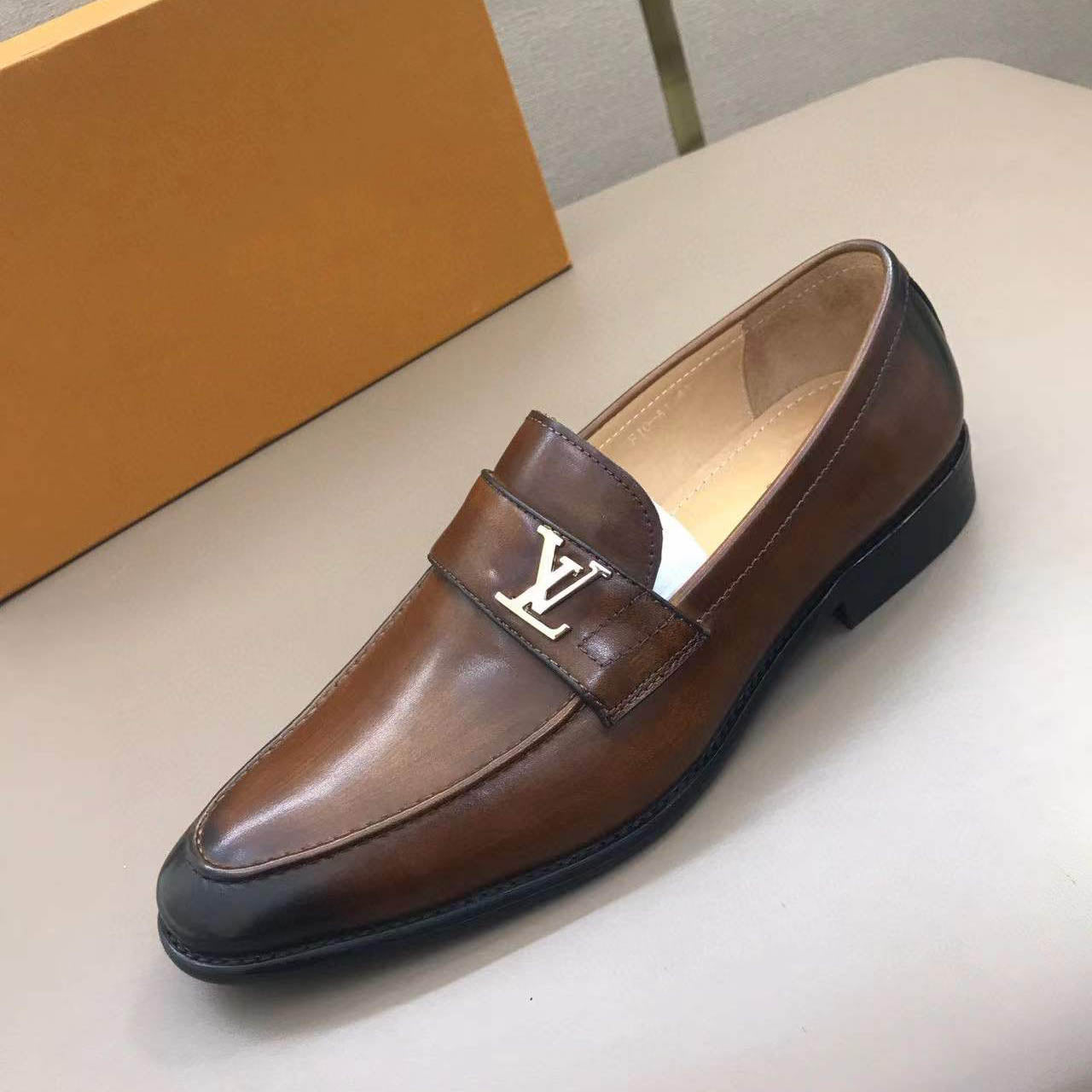 Brown leather shoes with small logo letters